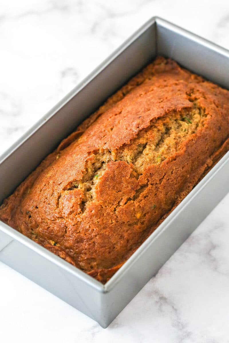 When life gives you zucchini, make this zucchini bread! It's so moist, the perfect amount of sweet, and has a subtle hint of cinnamon to it. Zucchini bread in a loaf pan.
