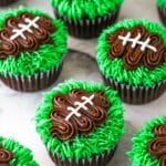finished football cupcakes set on a marble background