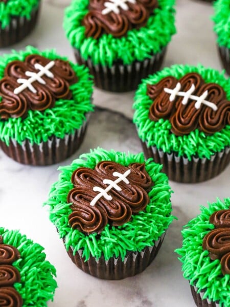 finished football cupcakes set on a marble background