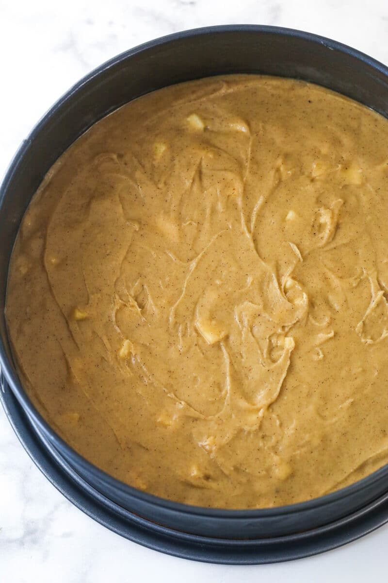 Apple blondie mixture spread into the bottom of a springform pan.