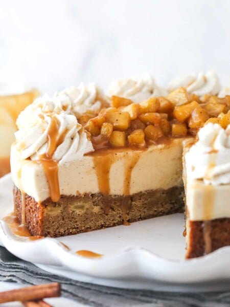A Caramel Apple Blondie Cheesecake with a slice removed to show inner layers.