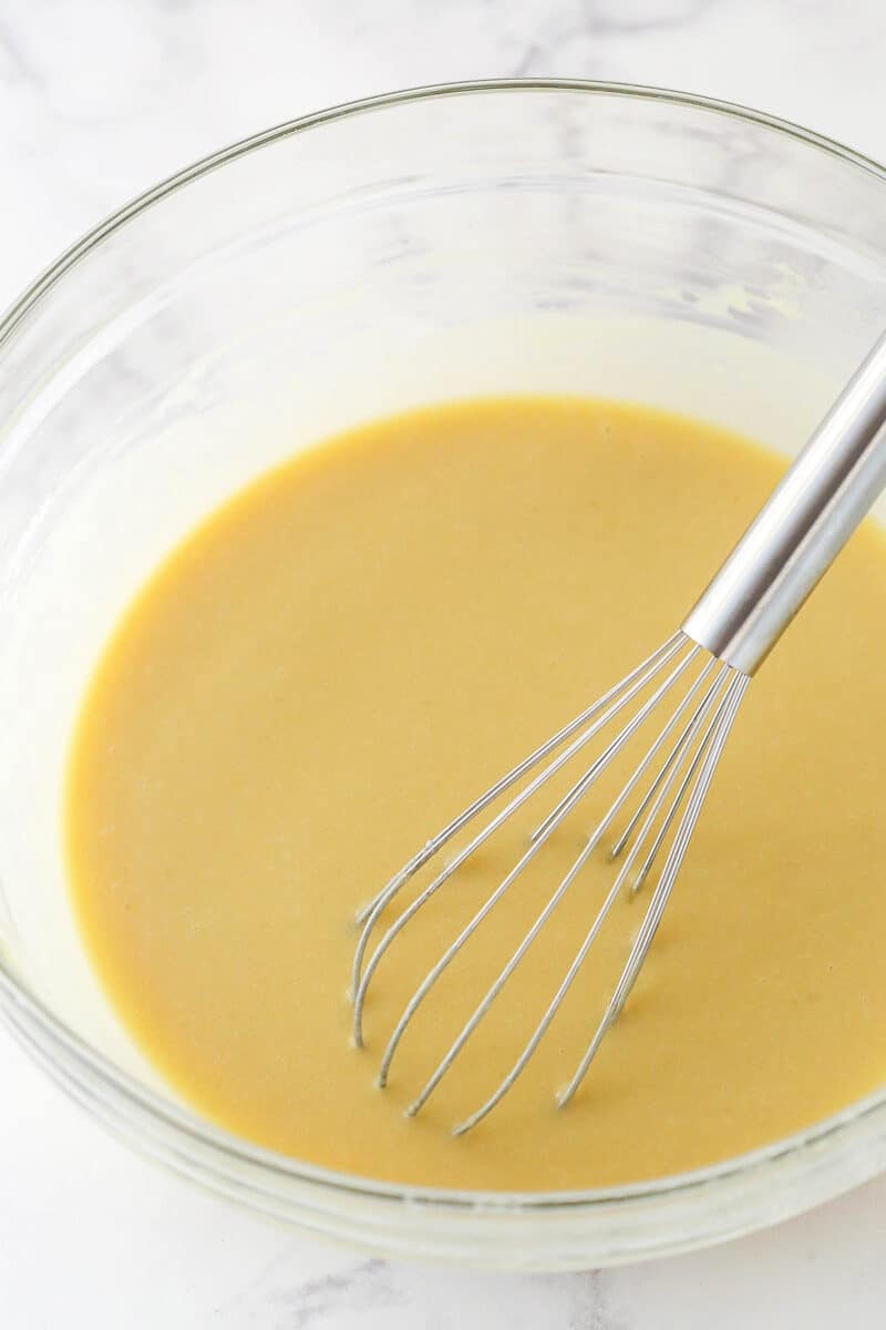 A mixing bowl with cupcake batter in it before adding the dry ingredients.