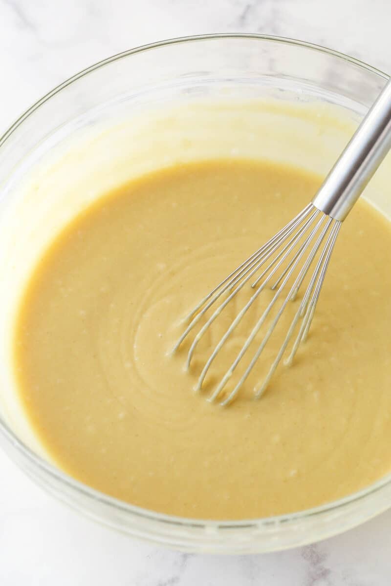 A mixing bowl with cupcake batter in it.