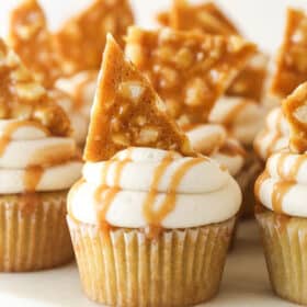 Close up of Macadamia Brittle Cupcakes on a cake plate.