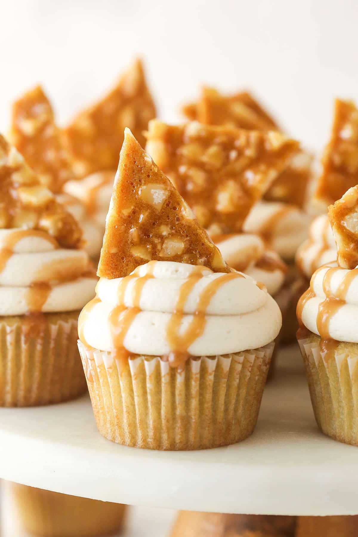 Close up of Macadamia Brittle Cupcakes on a cake plate.
