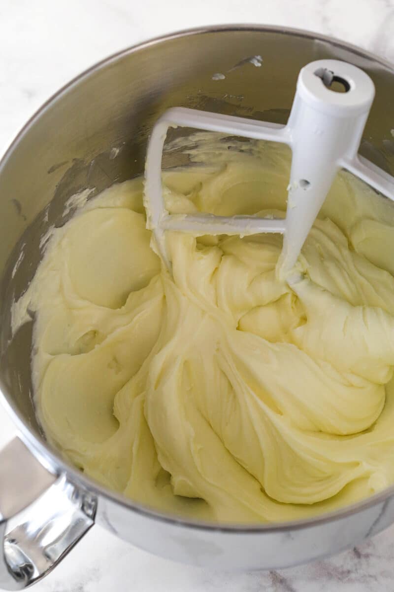 A mixing bowl with mixed cream cheese and sugar.