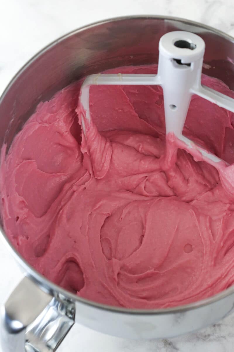 Cheesecake batter in a metal mixing bowl after the gelatin has been added.