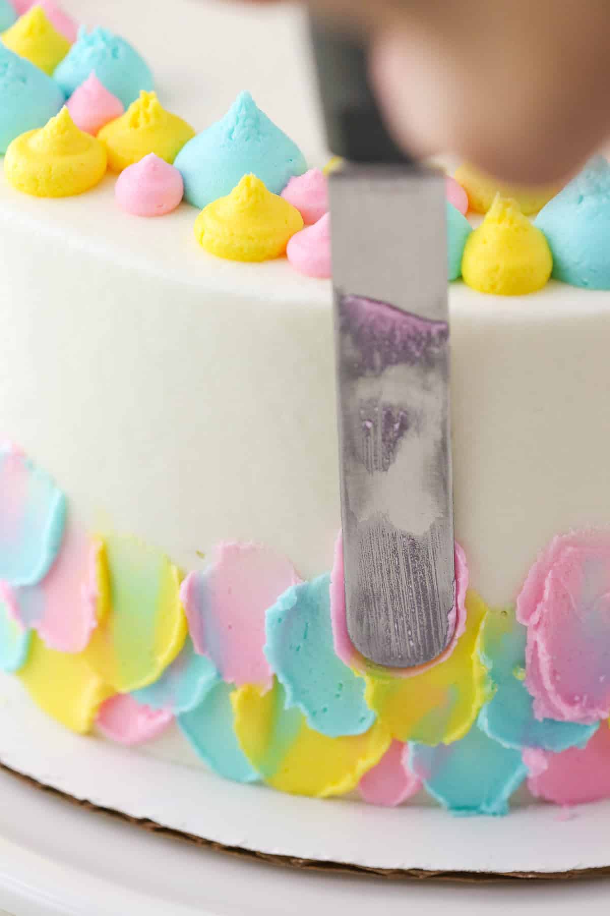 Applying frosting to an Almond Custard Layer Cake using an offset spatula
