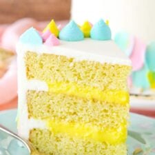 An upright slice of Almond Custard Layer Cake on a plate.