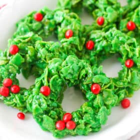 Christmas cornflake wreath cookies on a white plate