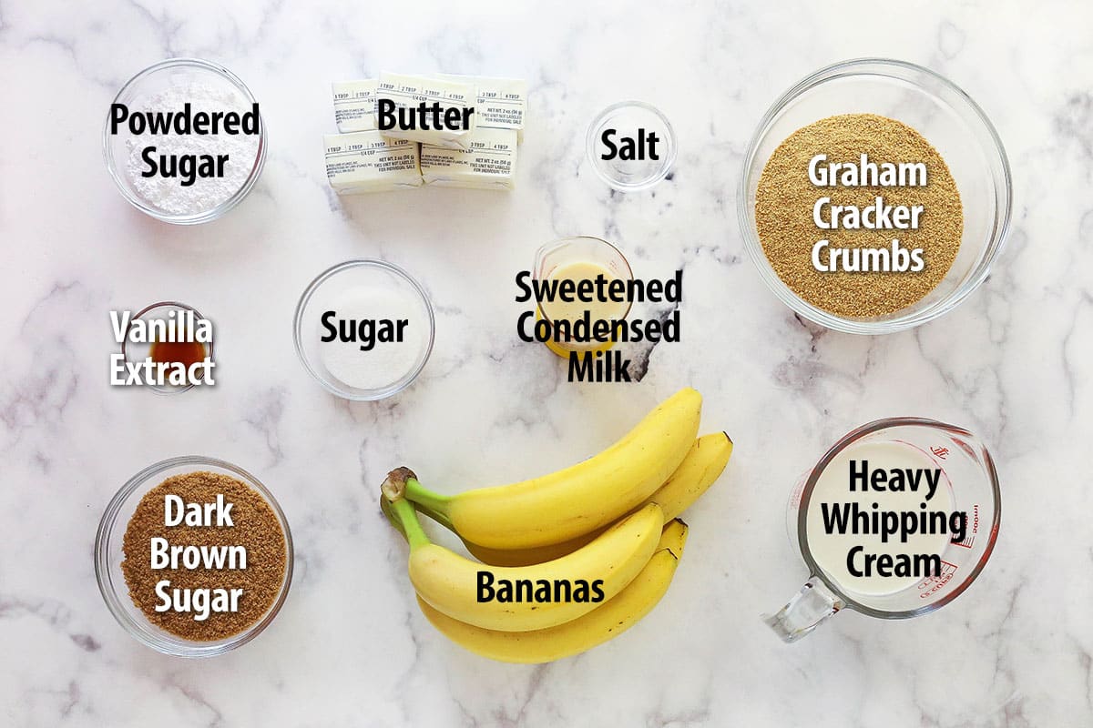 Banoffee Pie is an irresistible dessert made with a graham cracker crust, toffee filling, banana slices, and whipped cream. Overhead view of ingredients needed to make banoffee pie