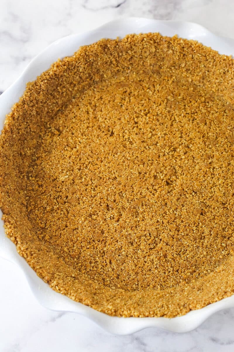 Banoffee Pie is an irresistible dessert made with a graham cracker crust, toffee filling, banana slices, and whipped cream. Graham cracker crust pressed into a pie pan