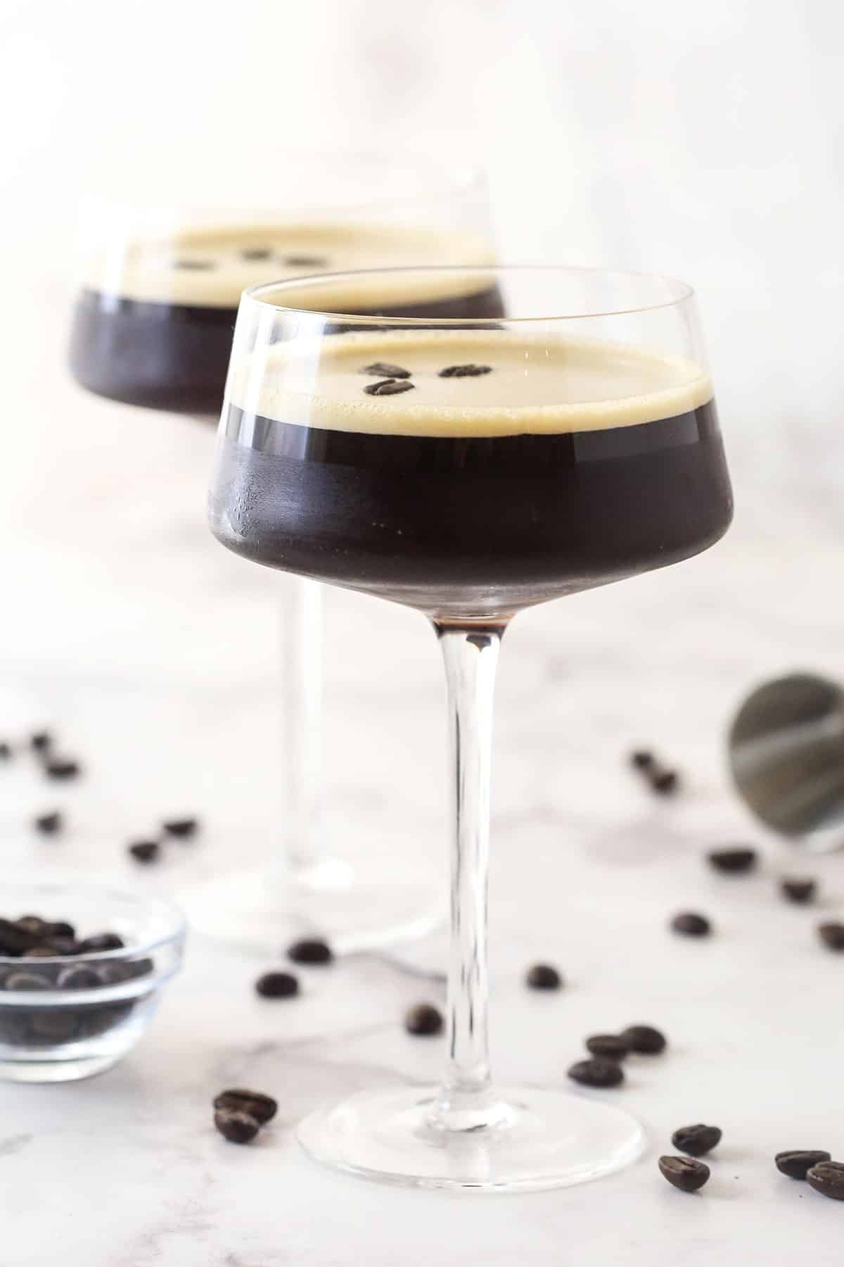Espresso, vanilla vodka, and espresso vodka combine in this Espresso Martini recipe to make an elegant yet simple cocktail. Two espresso martinis in martini glasses