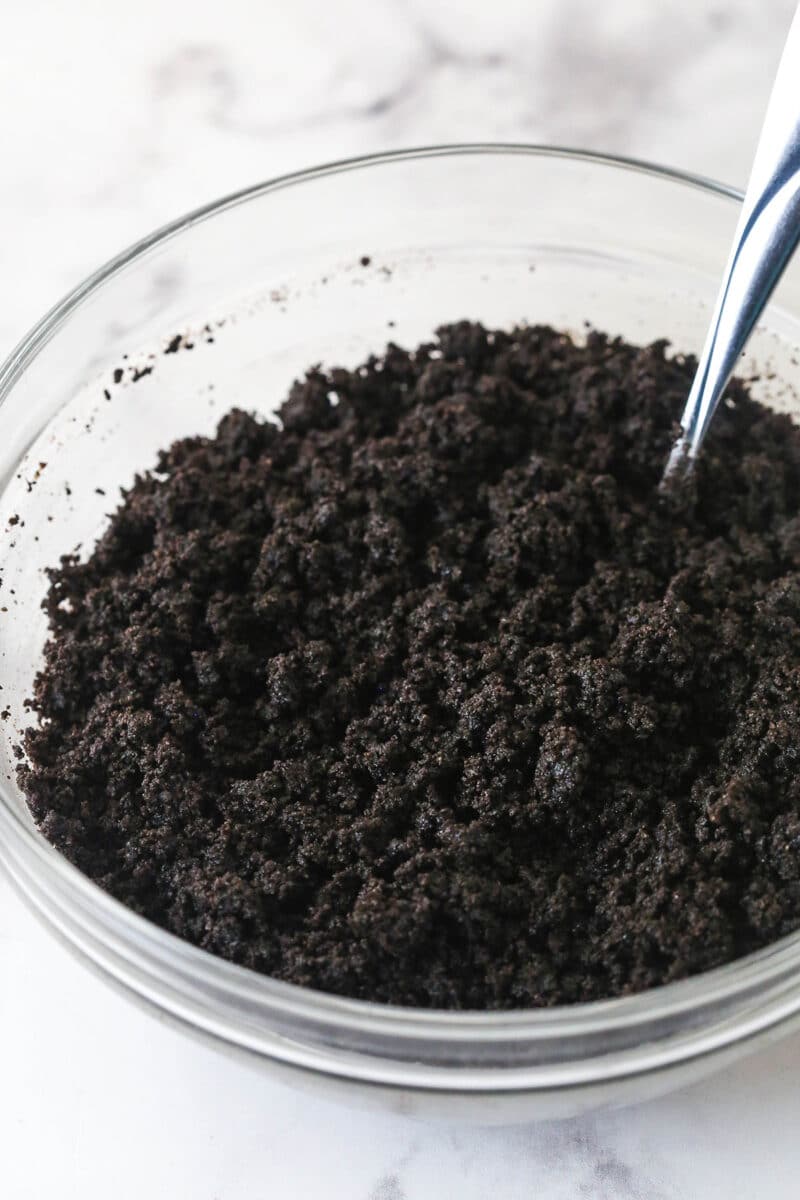 Oreo crumbs and butter in a bowl