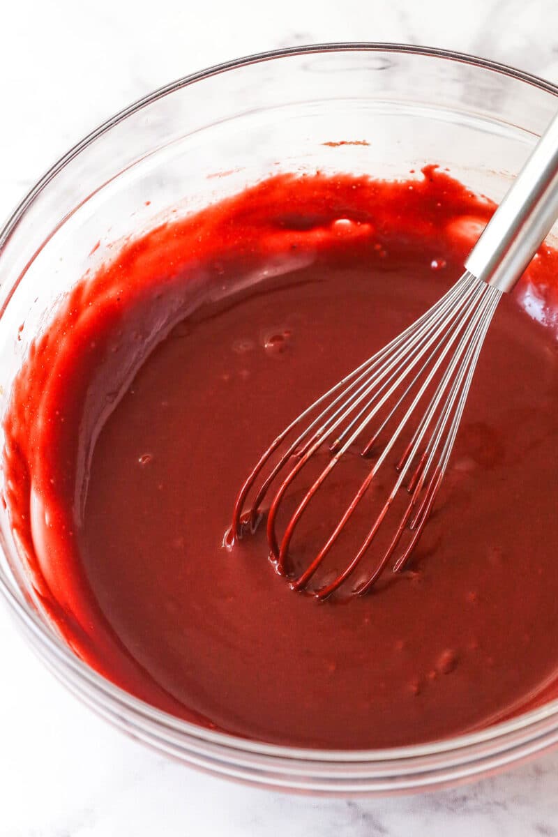 This red velvet cake roll is light and tender with the signature tang and hint of chocolate flavor. Perfect for Christmas & Valentine's Day! Red velvet cake batter in a bowl