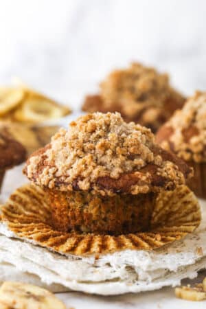 A Banana muffin with streusel topping, unwrapped and ready to enjoy.