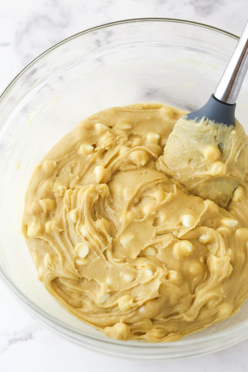 Folding white chocolate chips into blondie batter.
