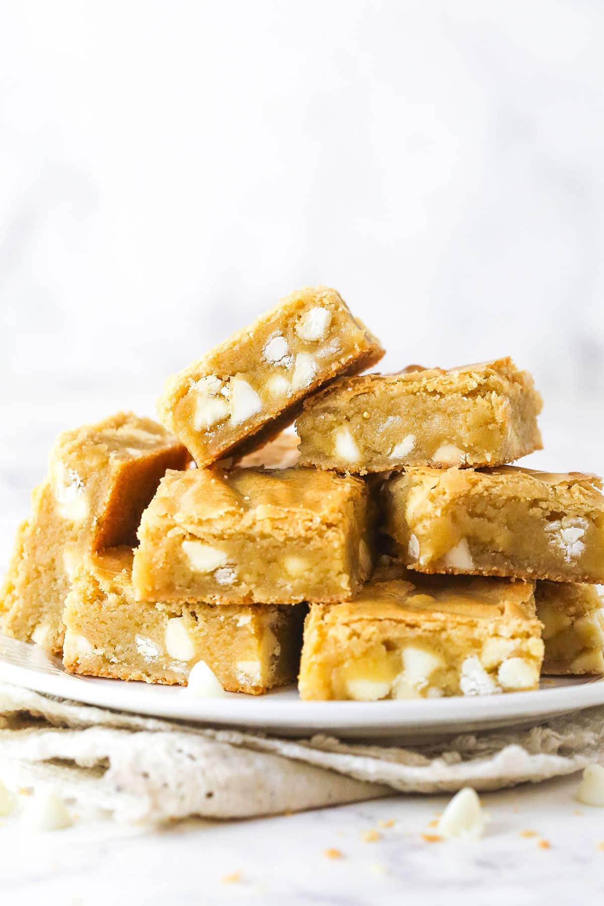 Blondies piled on a plate.
