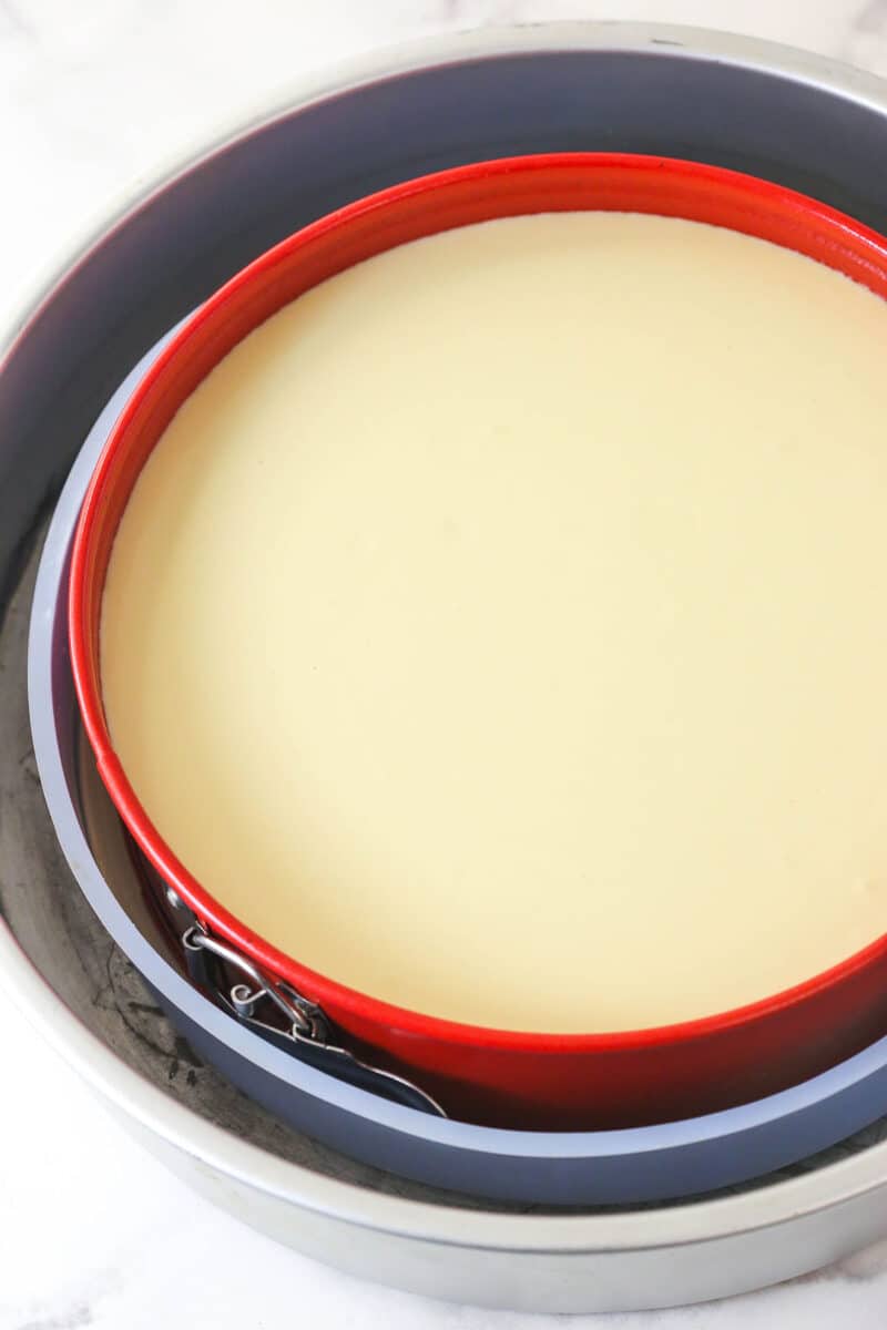 This Millionaire Cheesecake is next level! It's a tangy cheesecake doused in caramel and chocolate ganache atop a buttery shortbread crust. Cheesecake batter in a springform pan in a water bath.