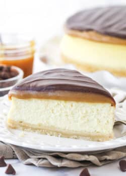 A slice of millionaire cheesecake on a plate.