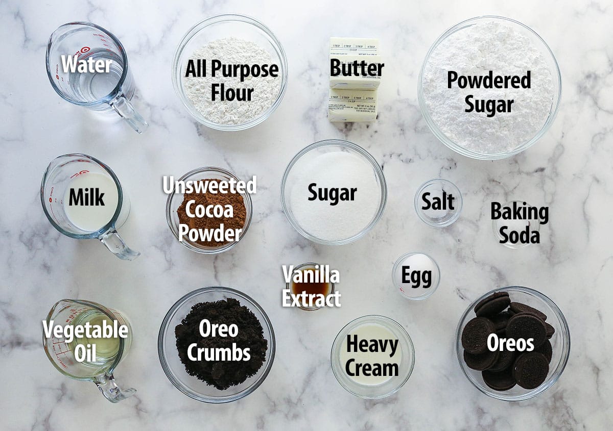 These Oreo Cupcakes are the answer to your Oreo craving! Creamy, Oreo-packed vanilla buttercream sits atop super moist chocolate cupcakes. Labeled ingredients for Oreo cupcakes spread out on a work surface.
