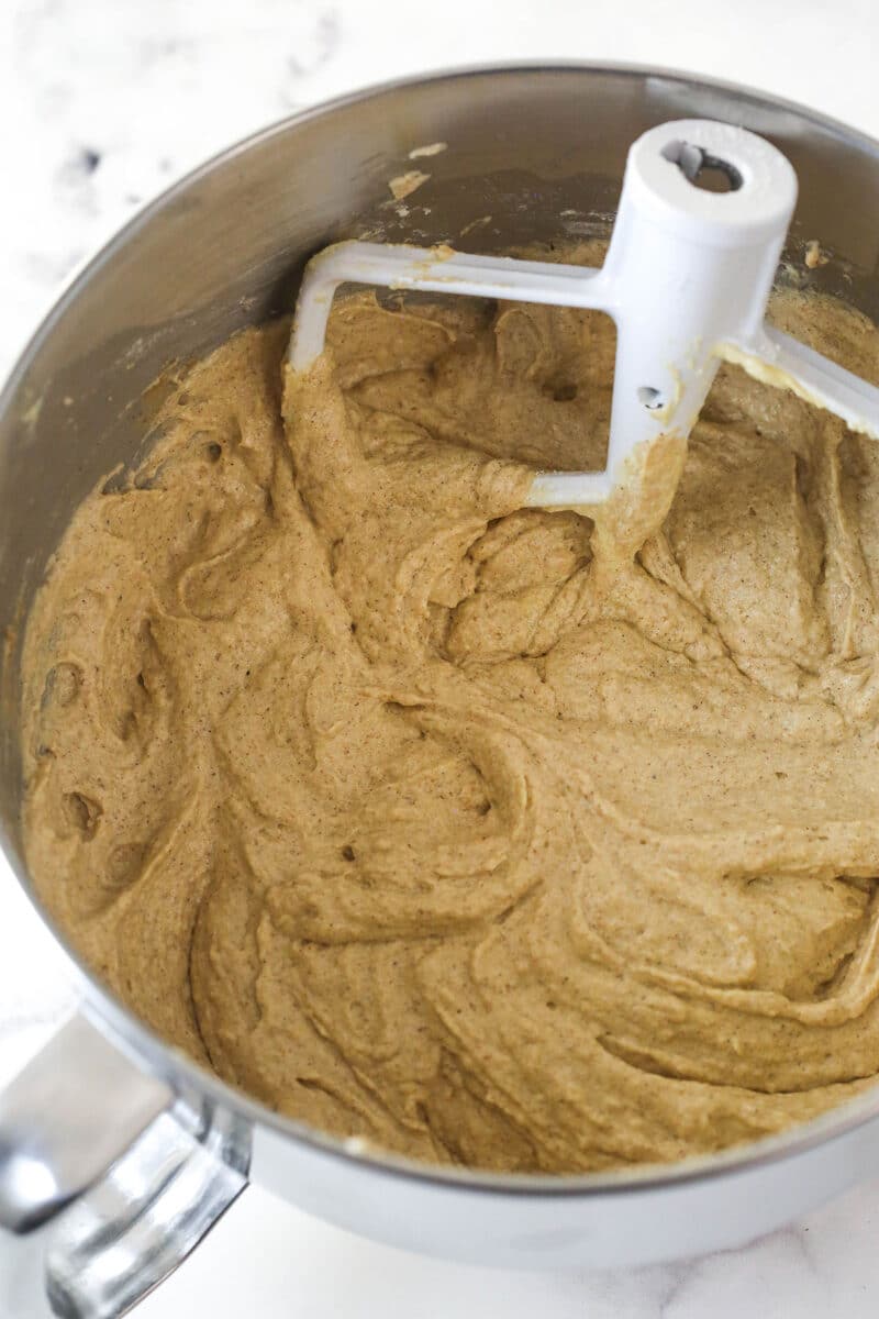 Combining the wet and dry ingredients for applesauce cake batter.