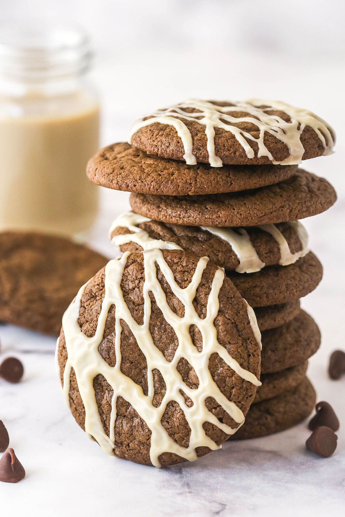 Baileys Chocolate Cookies Stack of Baileys Chocolate Cookies with some decorated with glaze and one cookie leaning on the side of the stack