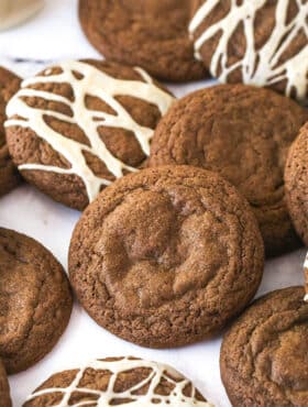 Baileys Chocolate Cookies laid out on a marble background, some with glaze and some without it.