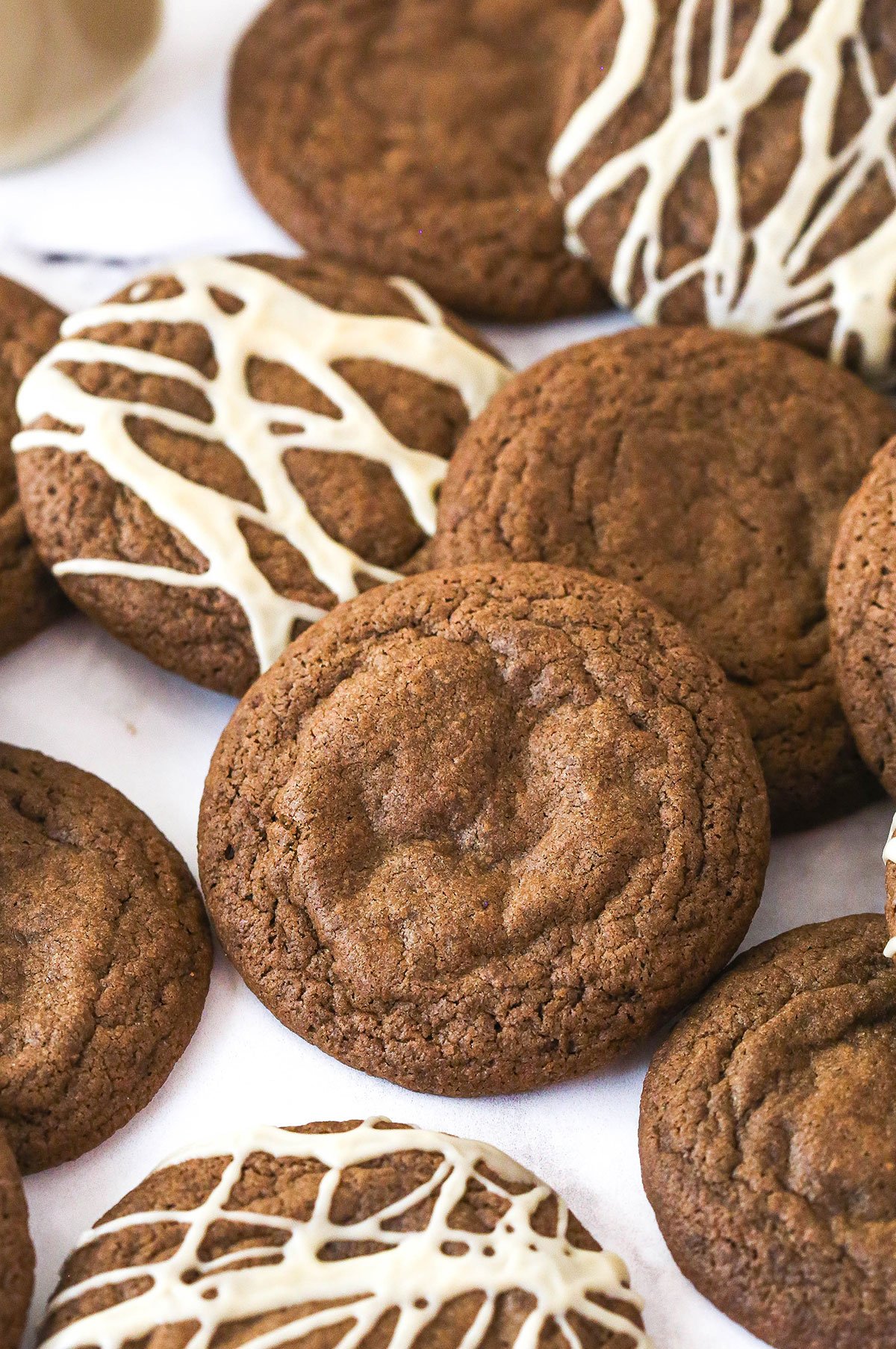 Baileys Chocolate Cookies laid out on a marble background, some with glaze and some without it.