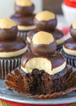 Close up of a peanut butter chocolate buckeye cupcake with a bite taken out of it.