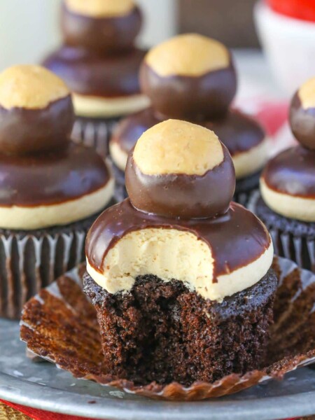 Close up of a peanut butter chocolate buckeye cupcake with a bite taken out of it.