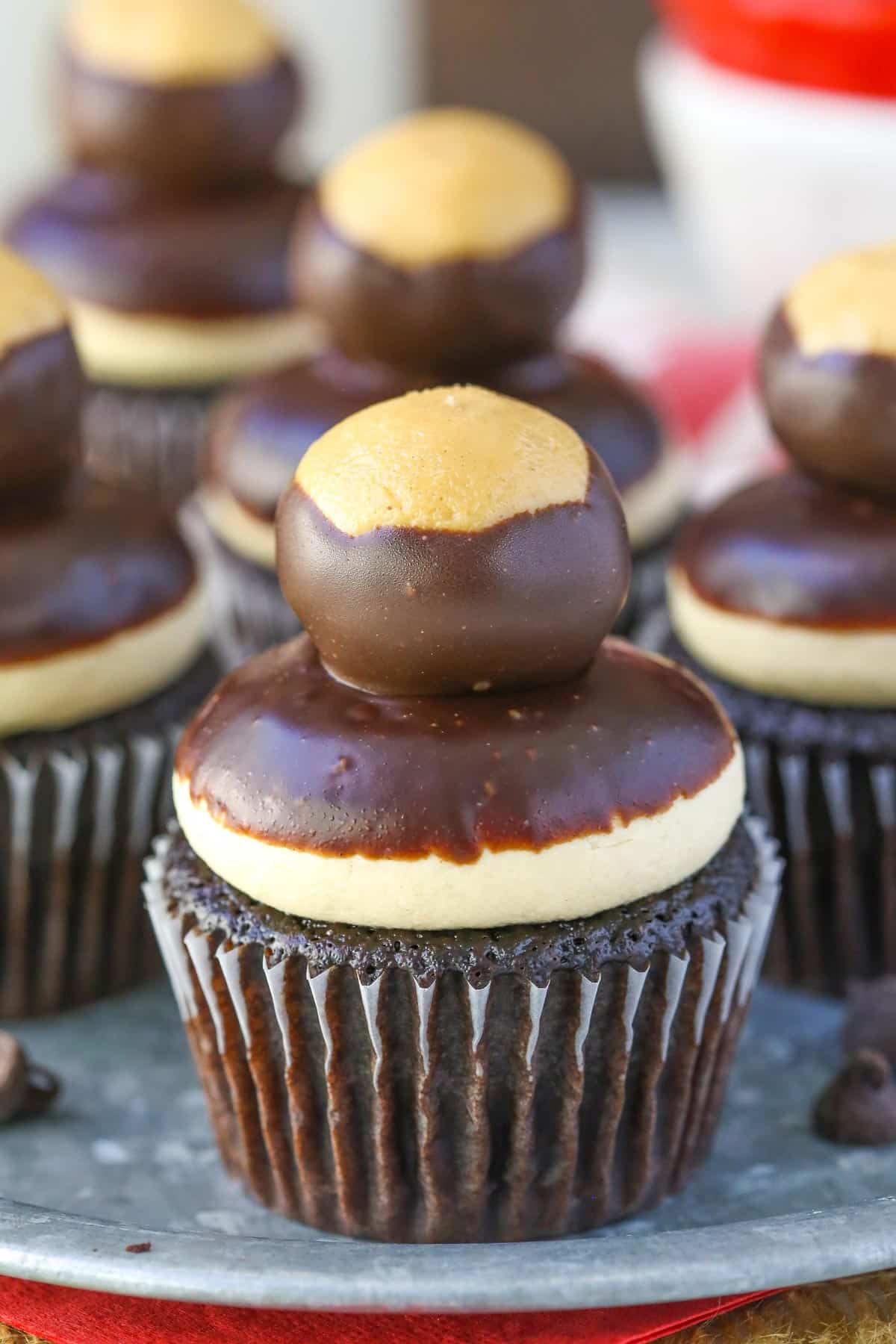 Close up of a peanut butter chocolate buckeye cupcake on a silver tray.
