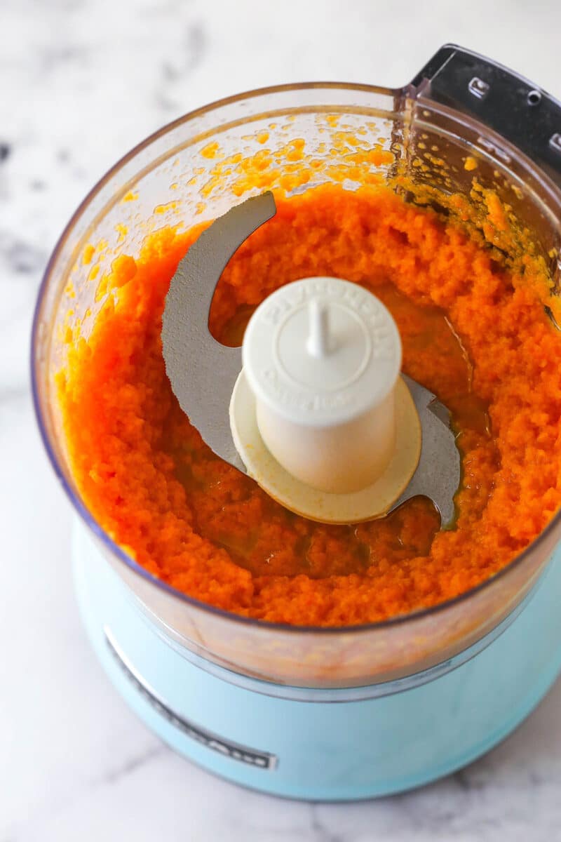 Pureeing steamed carrots and vegetable oil.