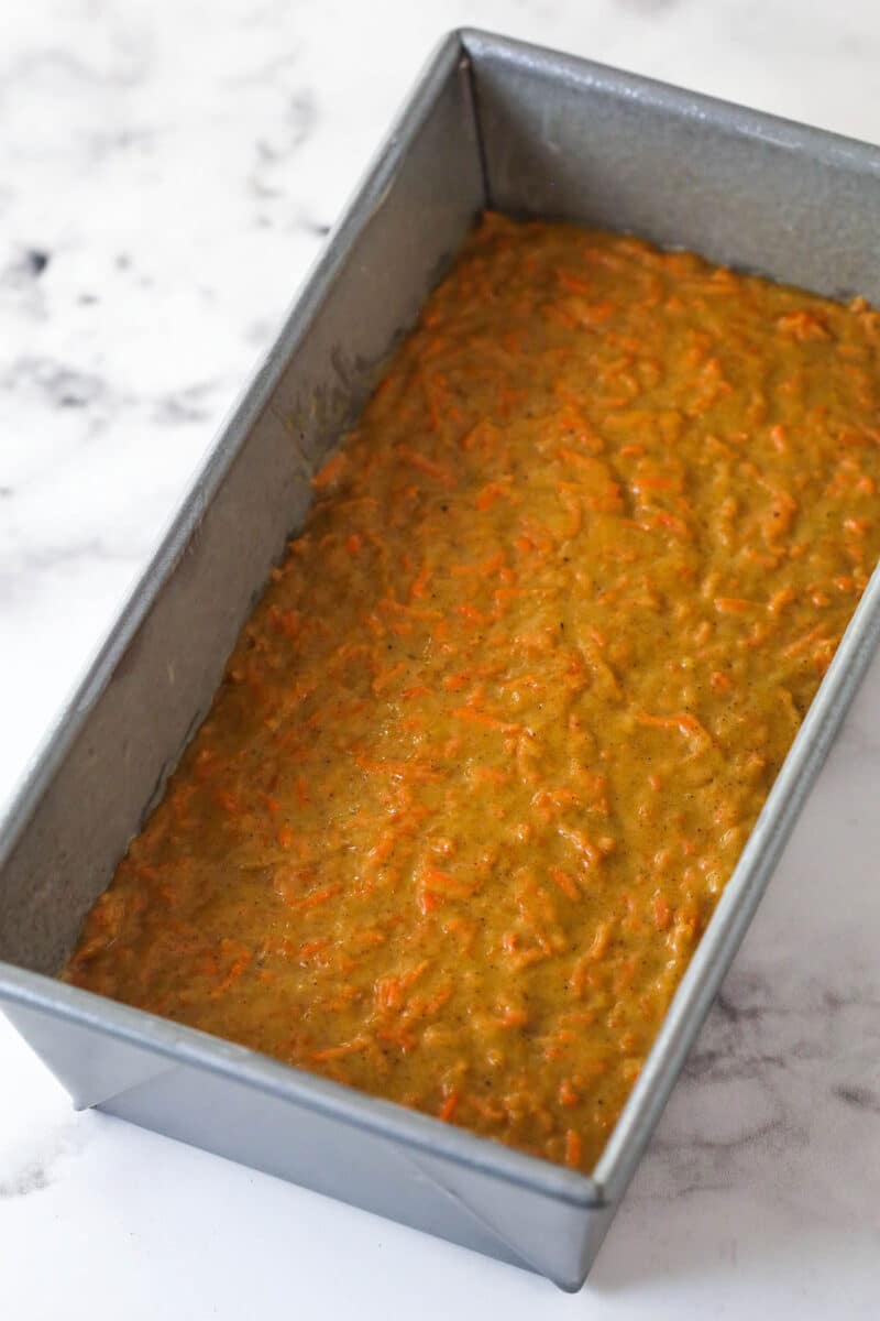 Batter for carrot cake loaf in a baking pan.