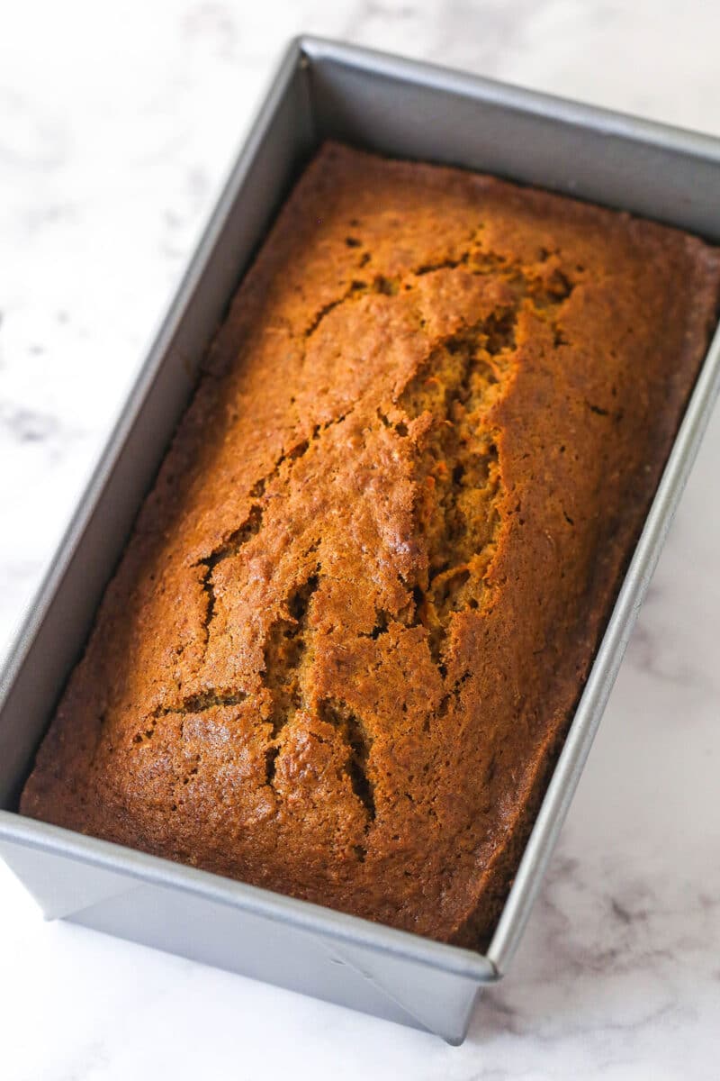 Carrot cake loaf cooling in a pan.
