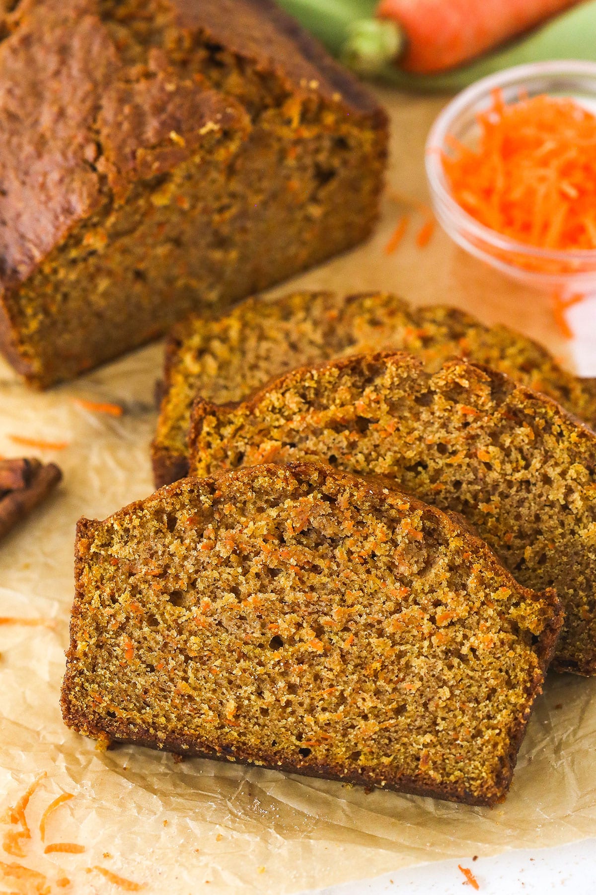 Slices of carrot cake loaf stacked on top of each other.