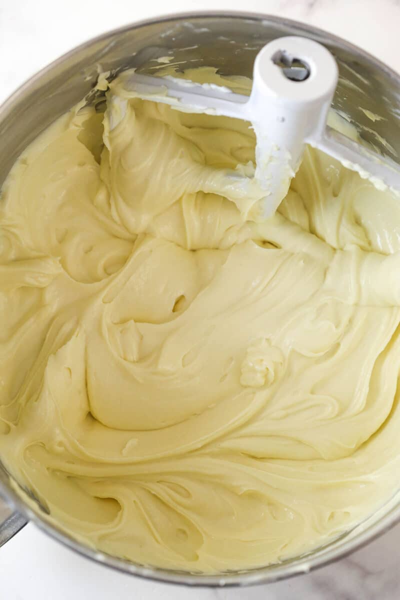 Mixing the the sour cream, vanilla, and cake batter flavoring into cheesecake batter.