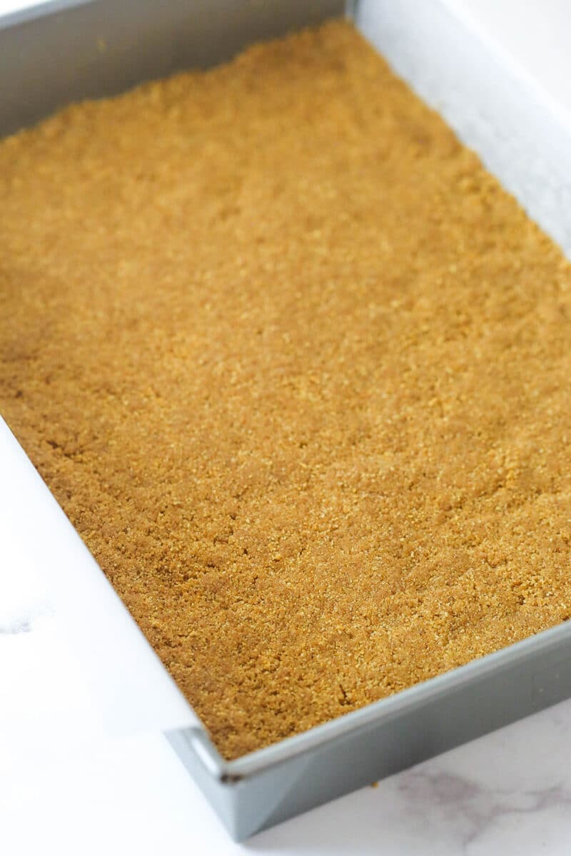 A graham cracker crust pressed into the bottom of a baking pan.