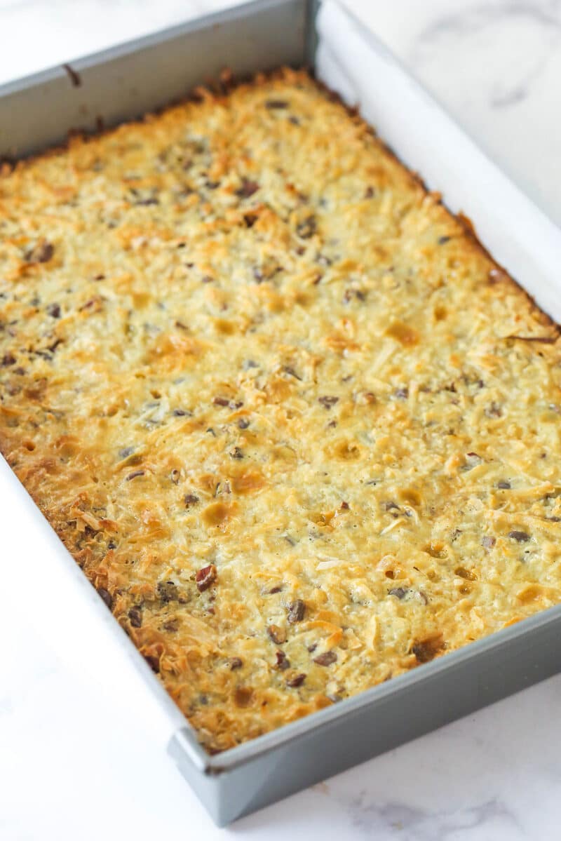 Magic cookie bars cooling in a pan.