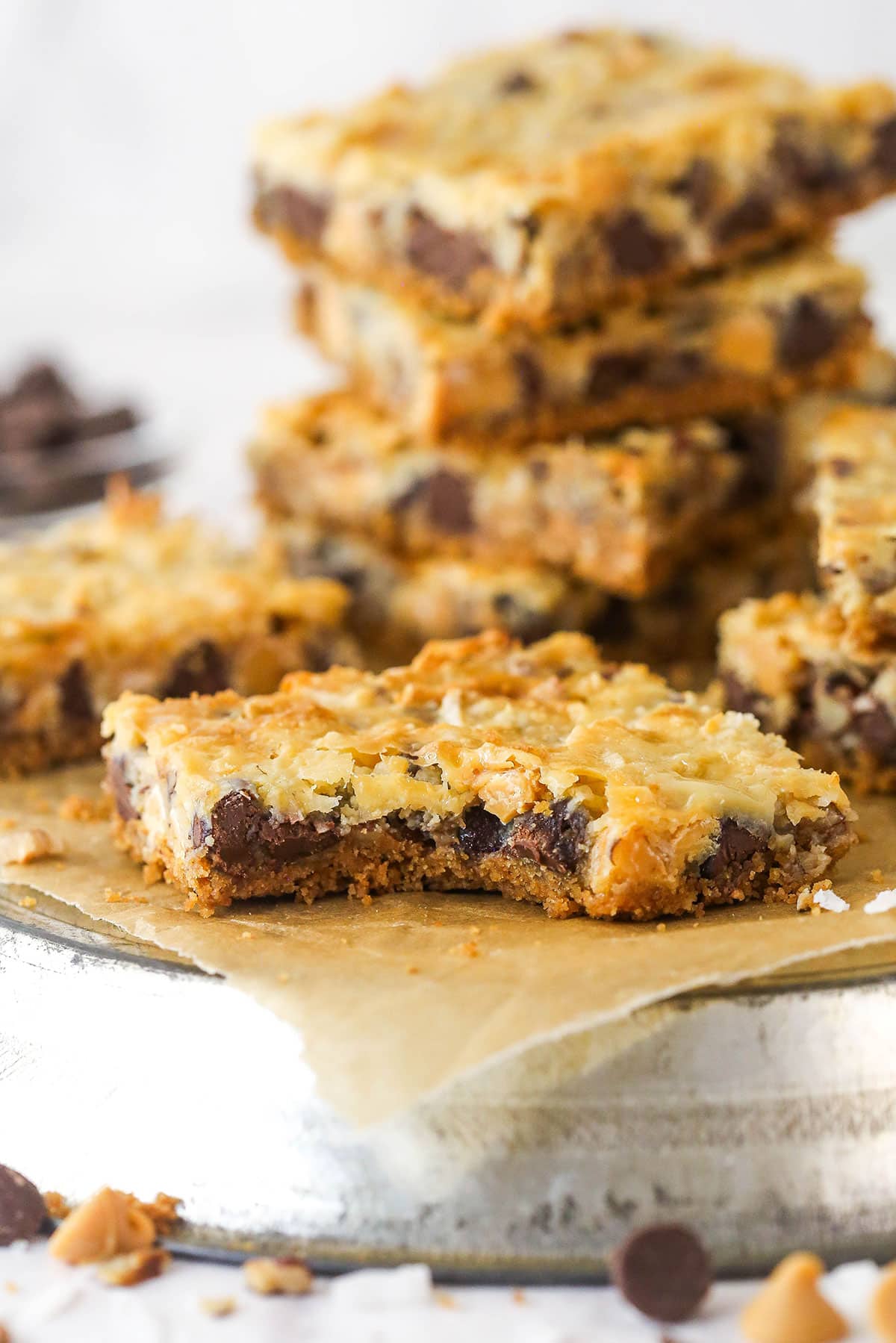 A magic cookie bar with a bite taken out of it.