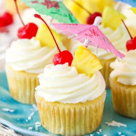 Pina colada cupcakes on a plate.
