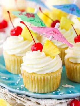 Pina colada cupcakes on a plate.