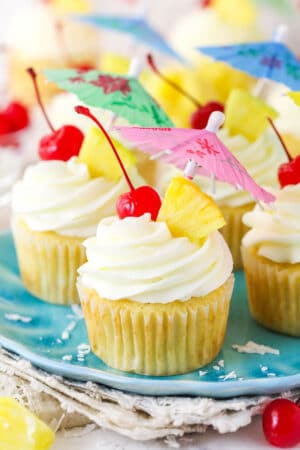 Pina colada cupcakes on a plate.