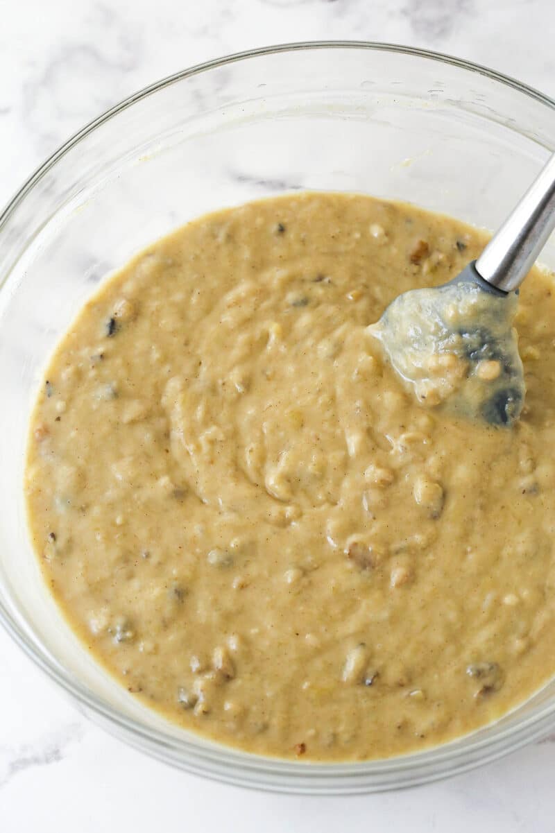 Folding walnuts into banana bread batter.