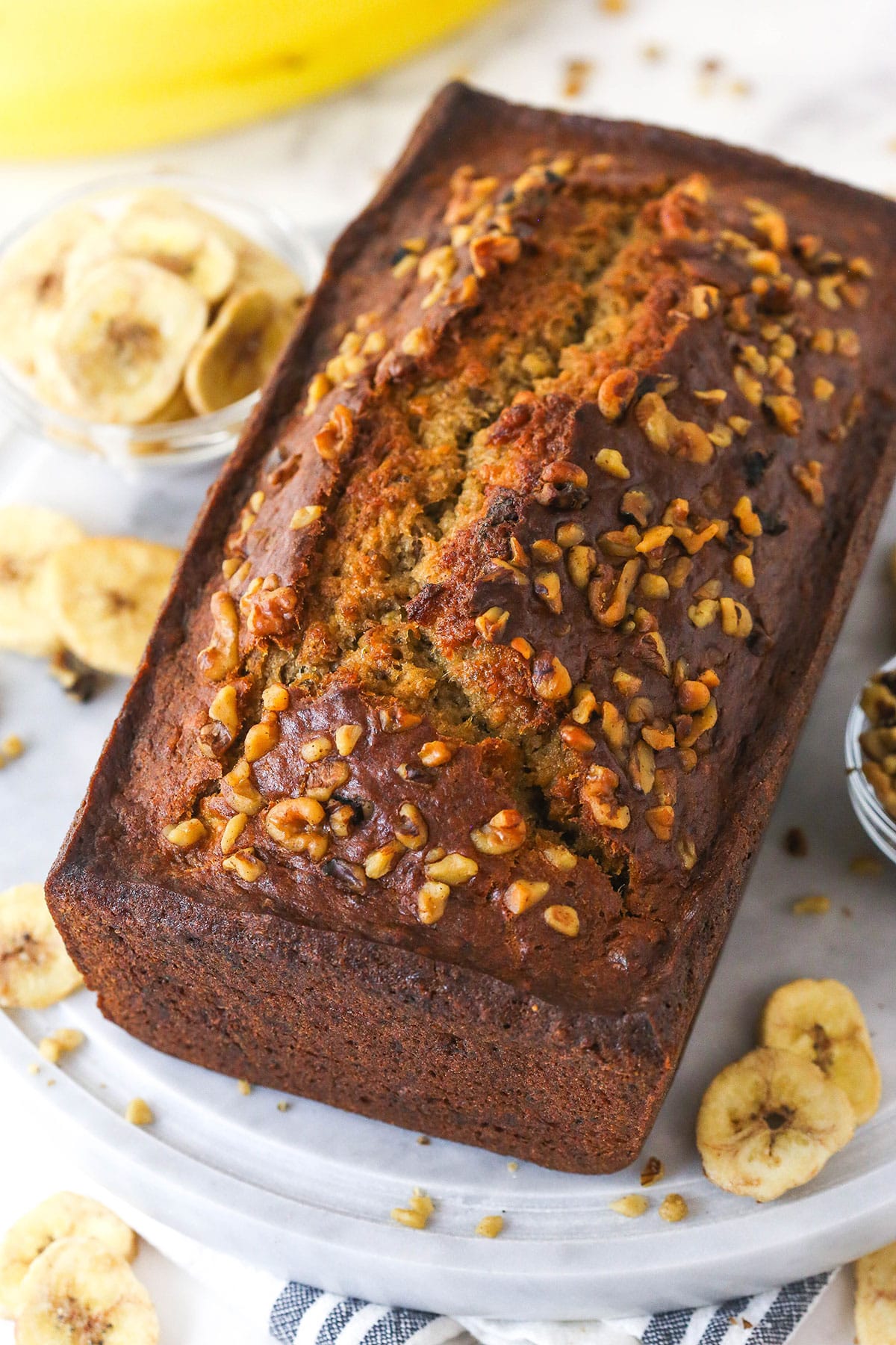 This easy Banana Nut Bread is top-notch. Supremely moist with BIG banana flavor and a hint of cinnamon, it's sure to become your new go-to! Overhead image of banana nut bread.