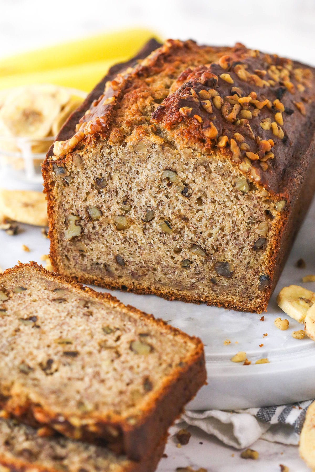 This easy Banana Nut Bread is top-notch. Supremely moist with BIG banana flavor and a hint of cinnamon, it's sure to become your new go-to! The inside of a banana nut bread loaf.