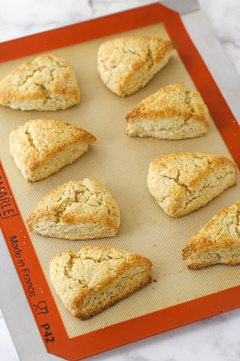 Plain baked scones on a silicon mat.
