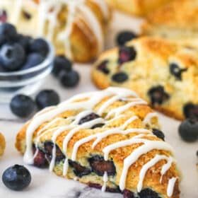 A blueberry scone with icing.