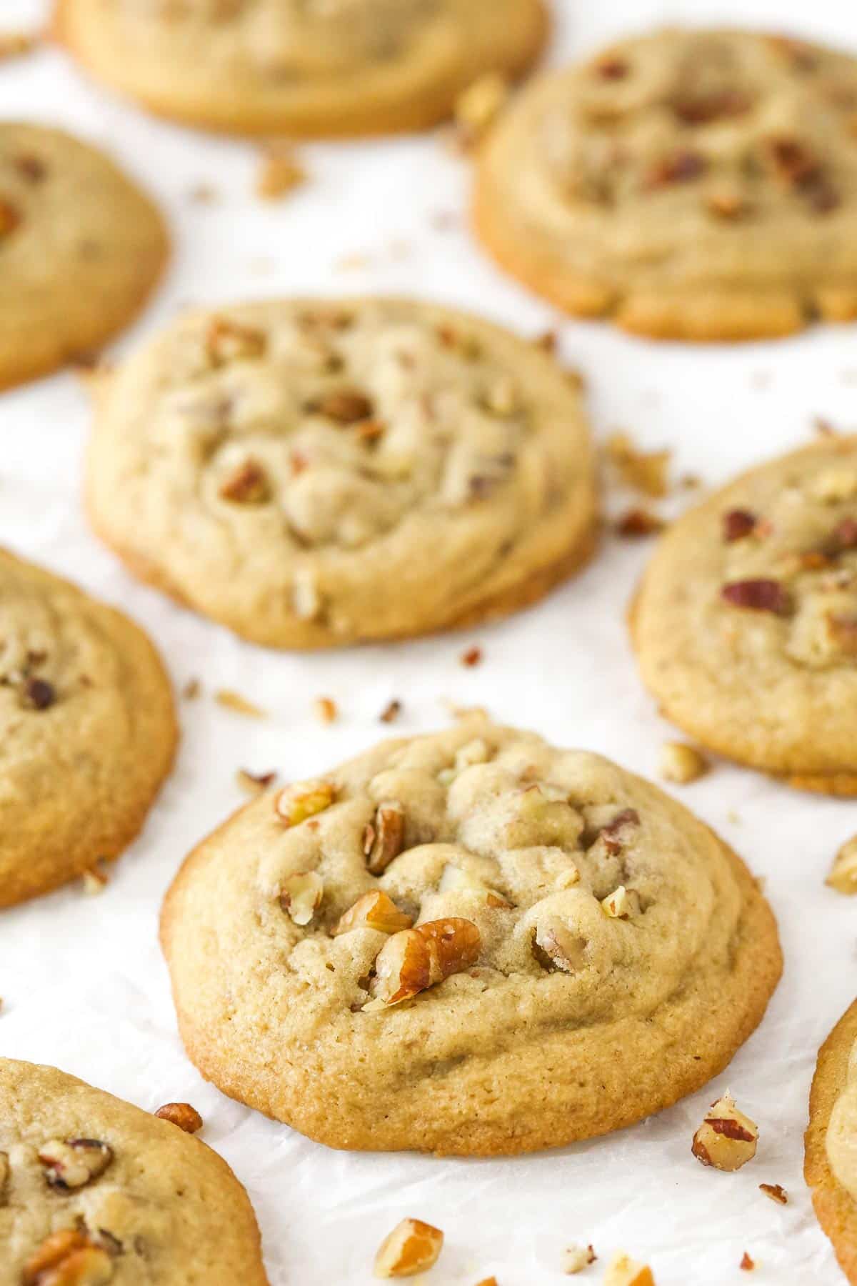 Close up of butter pecan cookies on a piece of parchment.