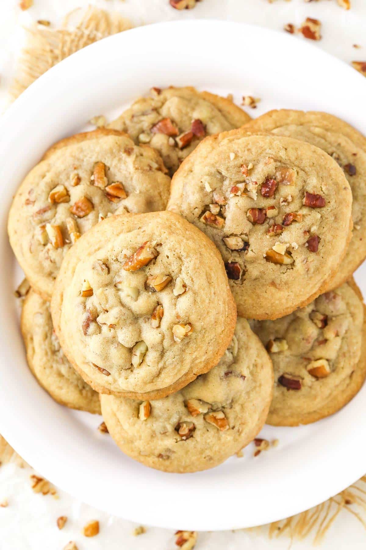 Overhead view of a plate full of butter pecan cookies.